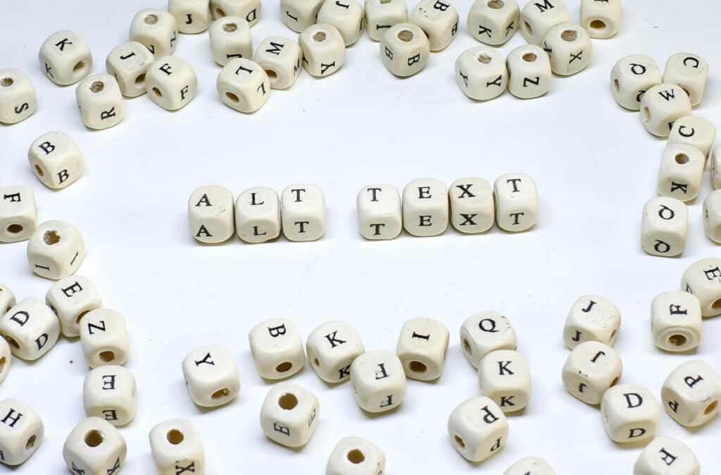 Beads featuring letters scattered on a white background, with some spelling out 'alt text'.