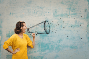 Woman shouting into line drawing of megaphone.