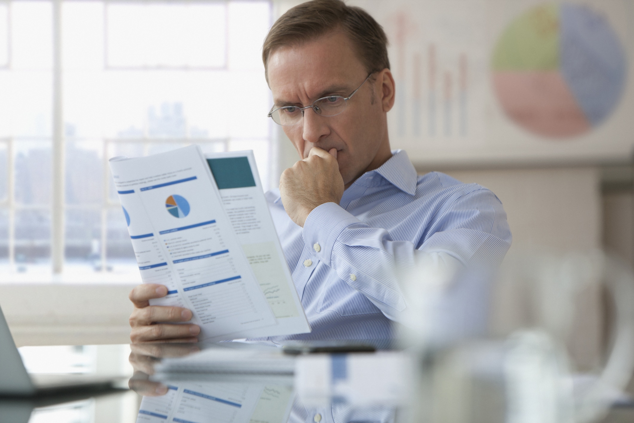 Man reading a report and thinking about it.