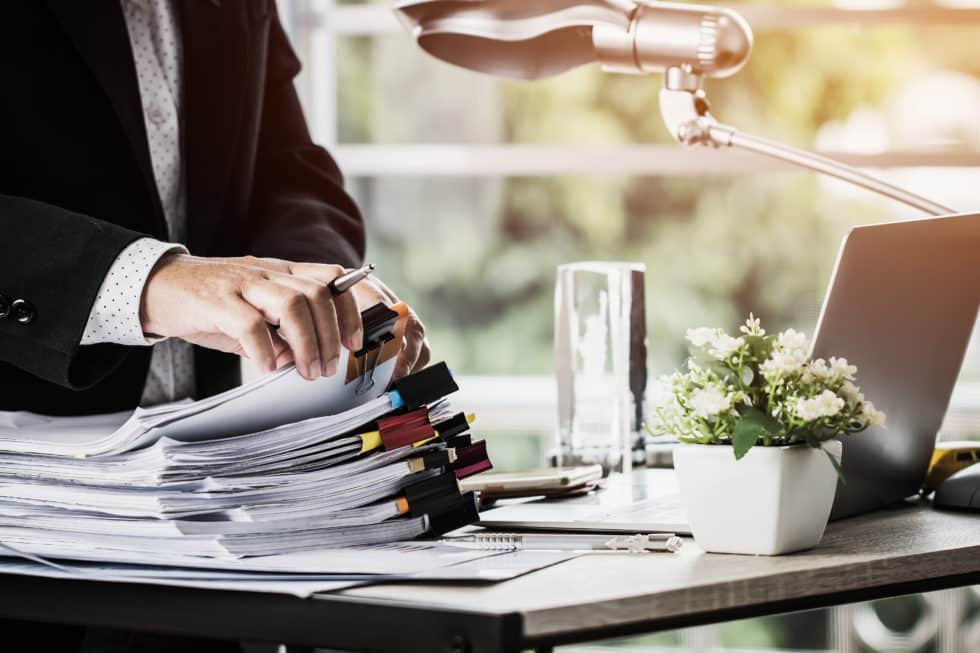 Pile of documents on a desk.